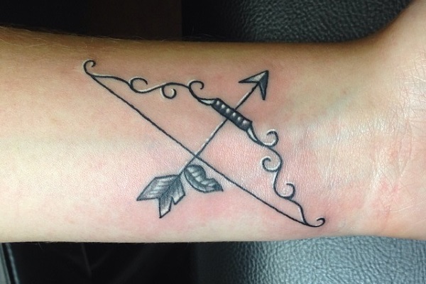 Black And Grey Arrow With Bow Tattoo On Left Wrist