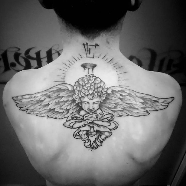 Black And Grey Baby Angel Tattoo On Man Upper Back