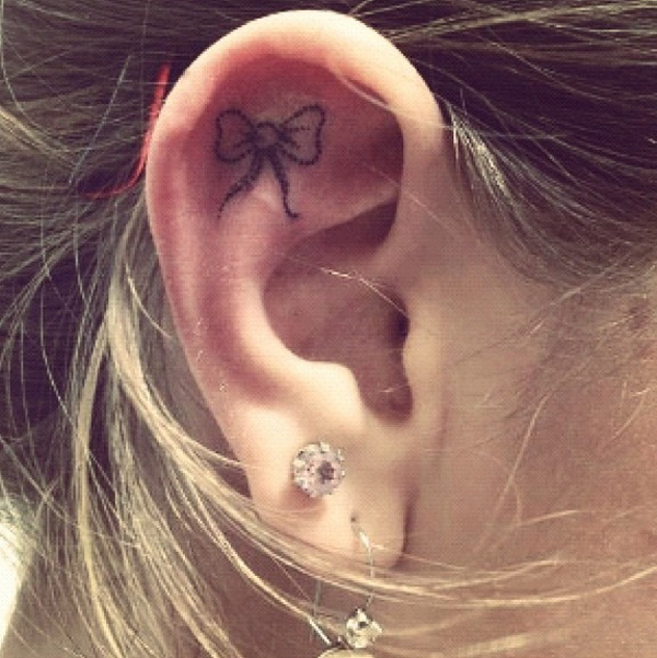 Black And Grey Bow Tattoo On Right Ear