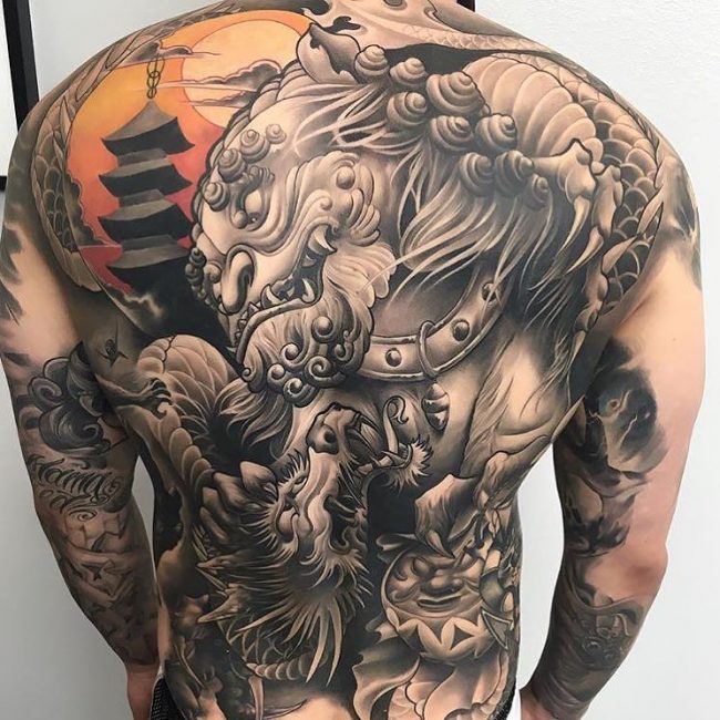 Black And Grey Foo Dog Tattoo On Man Full Back