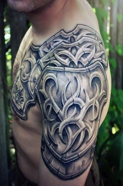 Black And Grey Tribal Armor Tattoo On Man Left Shoulder