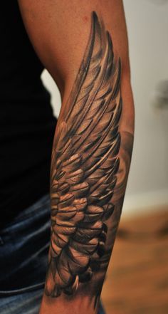 Black And Grey Wings Tattoo On Left Arm
