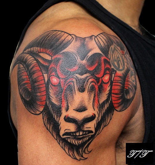 Black And Red Aries Head Tattoo On Right Shoulder