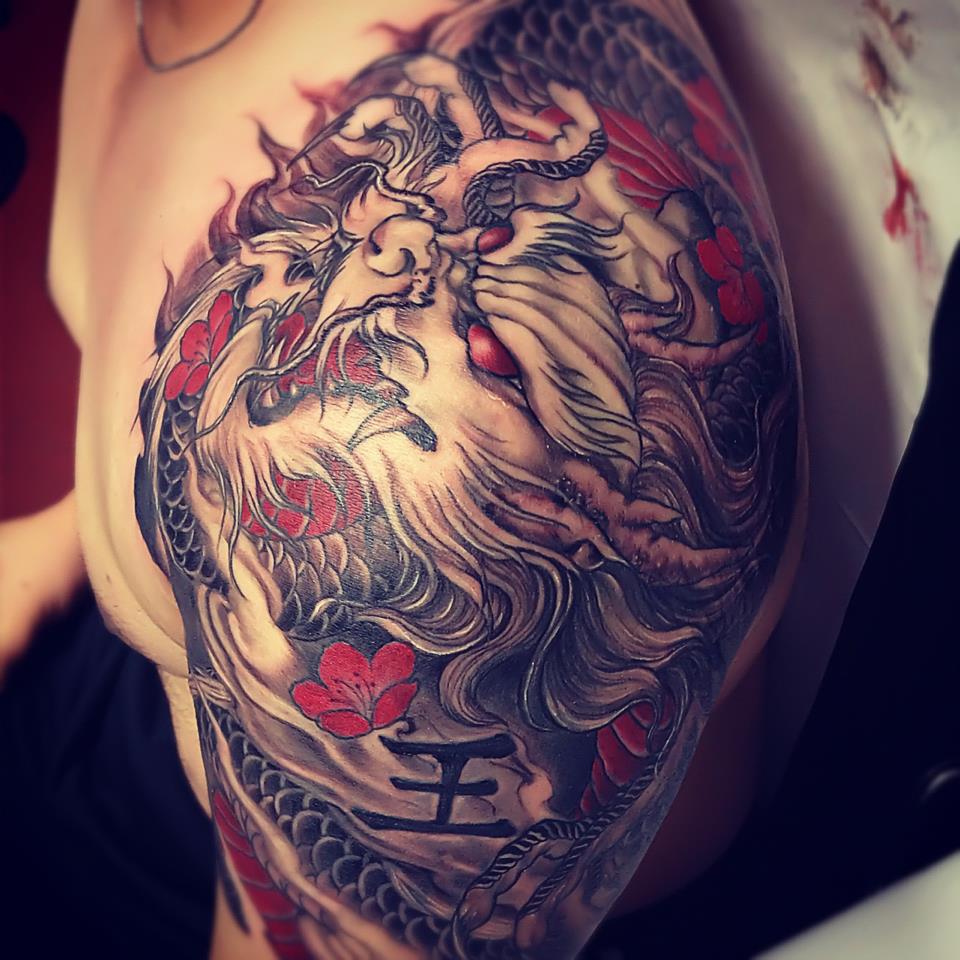 Black And Red Asian Dragon With Flowers Tattoo On Left Shoulder