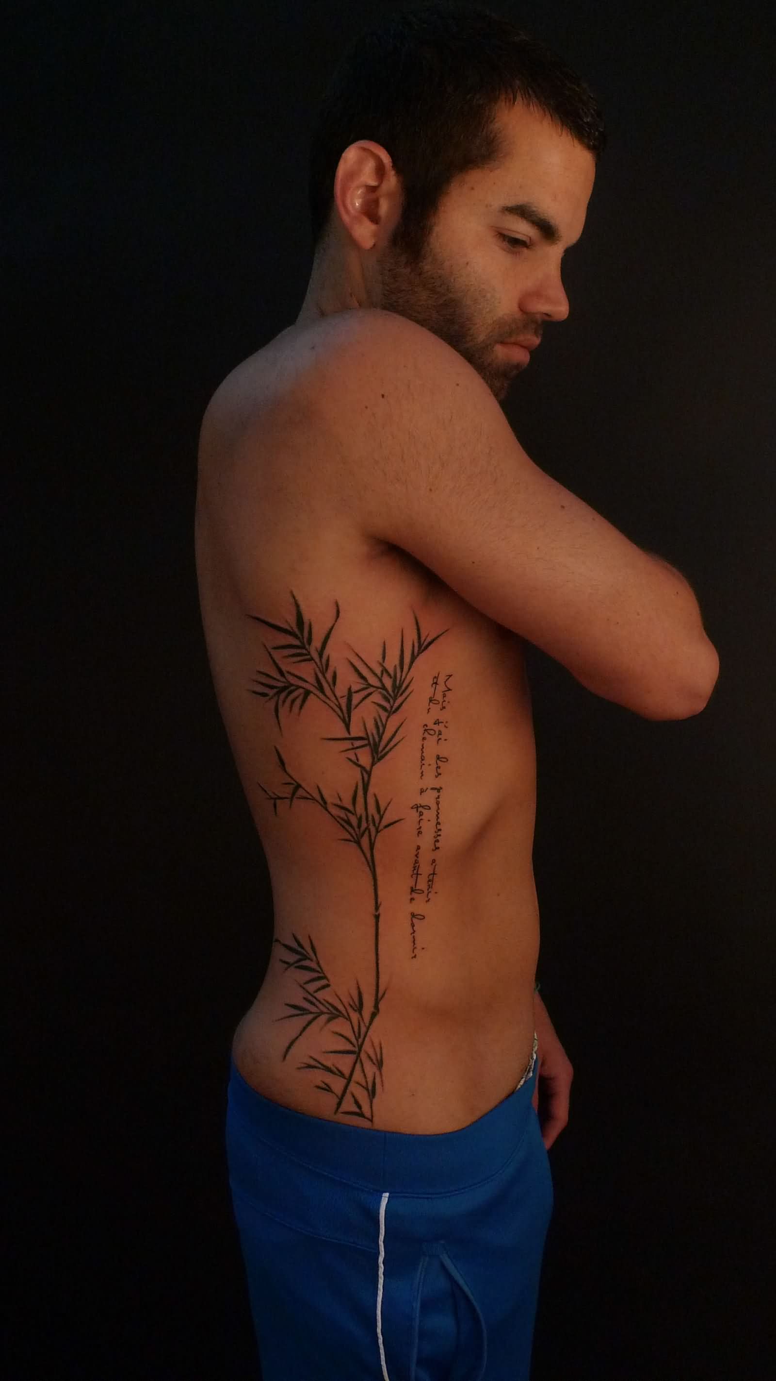 Black Bamboo Tree Tattoo On Man Right Side Rib
