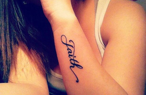 Black Faith Lettering Tattoo On Women Left Arm