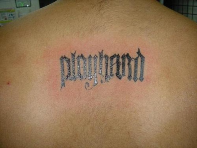 Black Ink Ambigram Playhard Tattoo On Man Upper Back