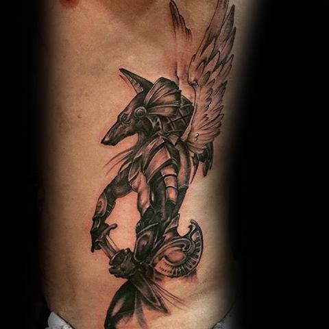 Black Ink Anubis With Wings Tattoo On Man Left Side Rib
