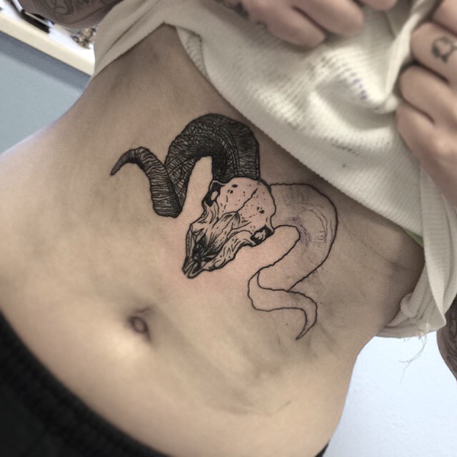 Black Ink Aries Skull Tattoo On Stomach