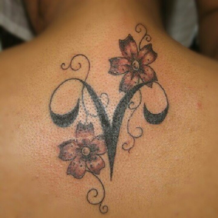 Black Ink Aries Symbol With Flowers Tattoo On Upper Back