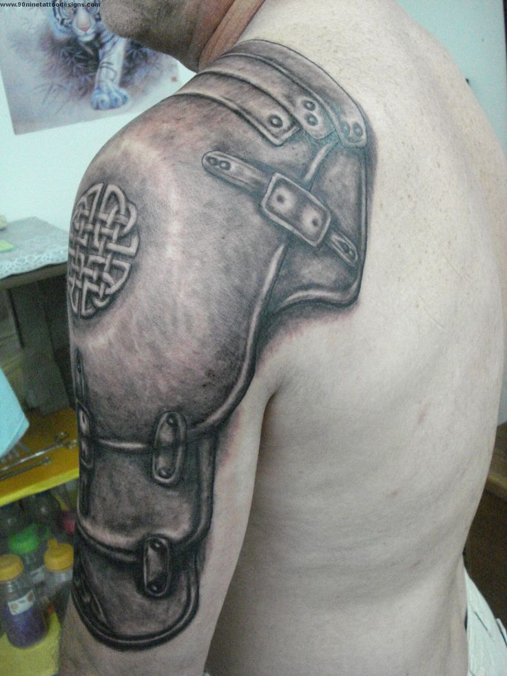 Black Ink Armor Tattoo On Man Left Shoulder