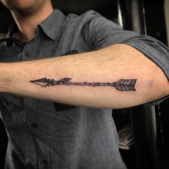 Black Ink Arrow Tattoo On Man Left Arm
