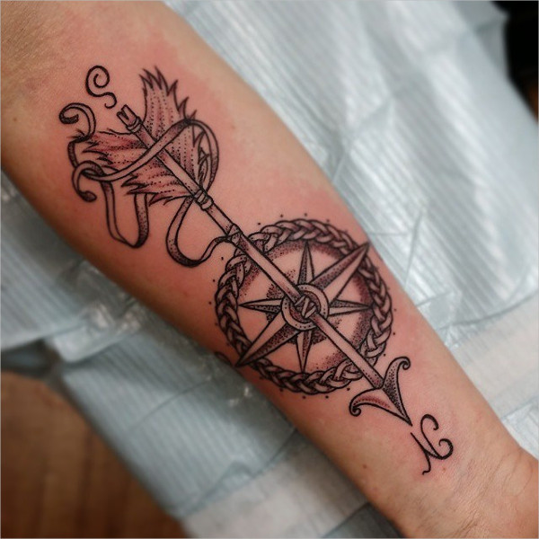 Black Ink Arrow With Nautical Compass Tattoo On Left Forearm
