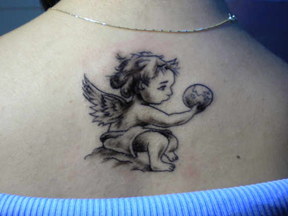 Black Ink Baby Angel Tattoo On Women Upper Back