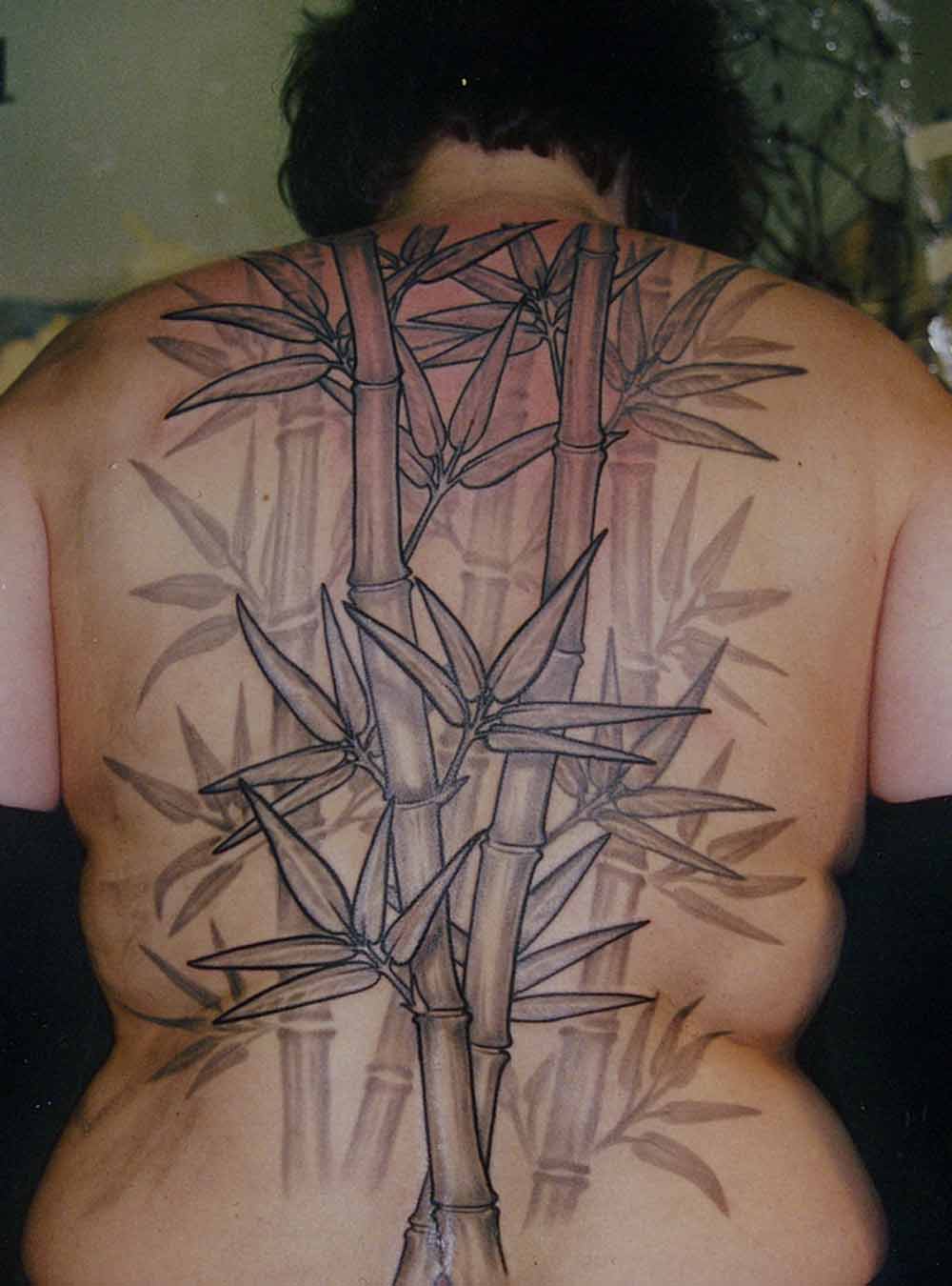 Black Ink Bamboo Tree Tattoo On Women Full Back