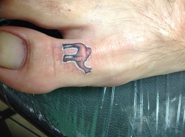 Black Ink Camel Tattoo On Right Foot Toe