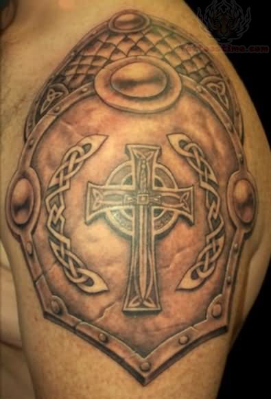Black Ink Cross Armor Tattoo On Man Left Shoulder