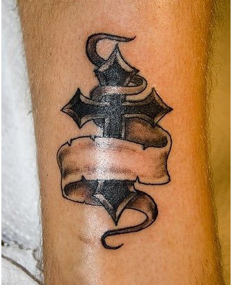 Black Ink Cross With Ribbon Tattoo On Ankle