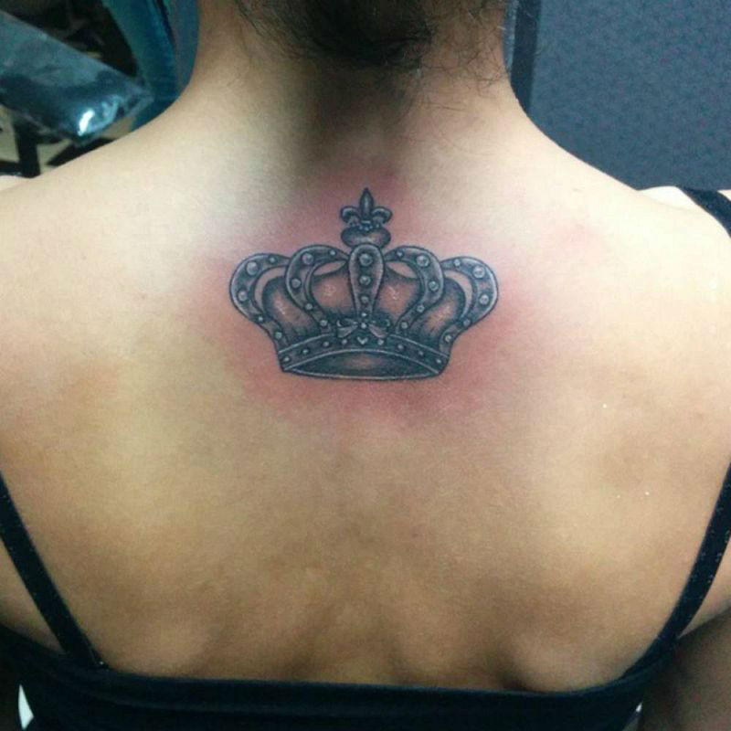 Black Ink Crown Tattoo On Women Upper Back