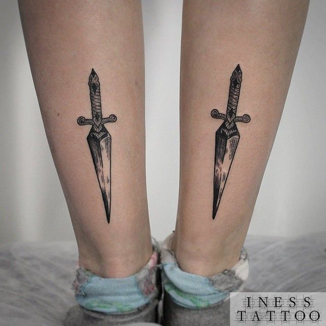 Black Ink Dagger Tattoo On Both Back Leg