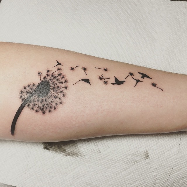 Black Ink Dandelion With Flying Birds Tattoo On Left Forearm