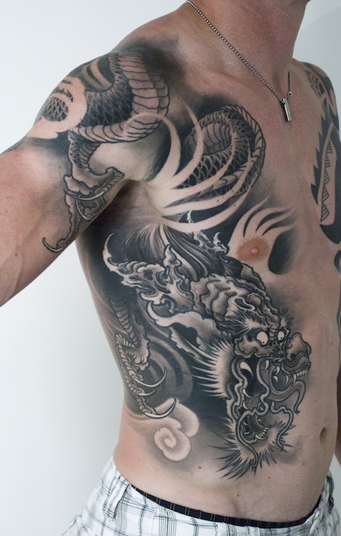 Black Ink Dragon Tattoo On Man Right Side Rib