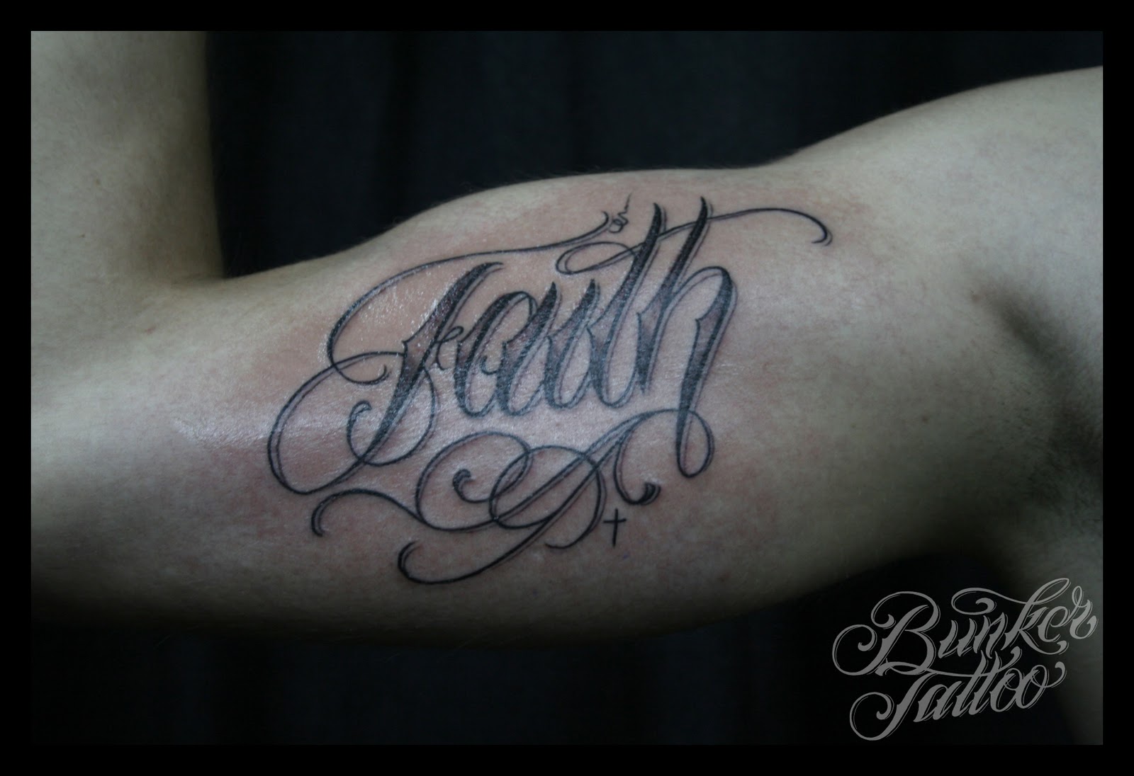 Black Ink Faith Lettering Tattoo On Right Bicep