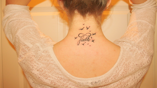 Black Ink Faith Lettering With Flying Birds Tattoo On Girl Back Neck