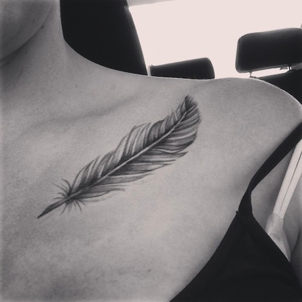 Black Ink Feather Tattoo On Left Front Shoulder