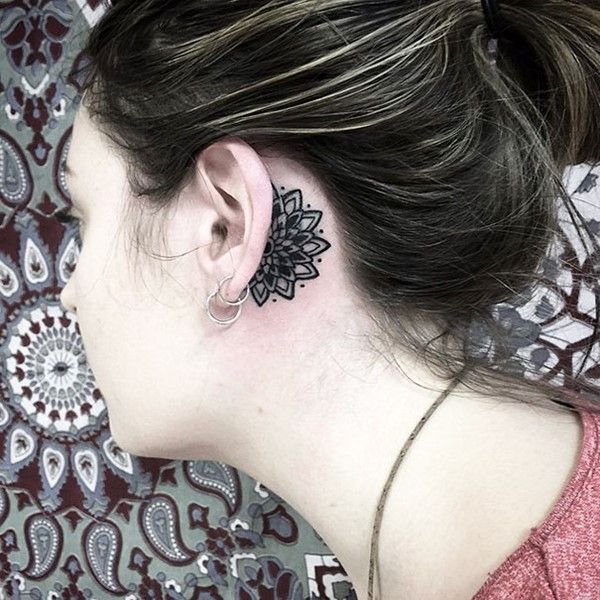 Black Ink Flower Tattoo On Girl Left Behind The Ear