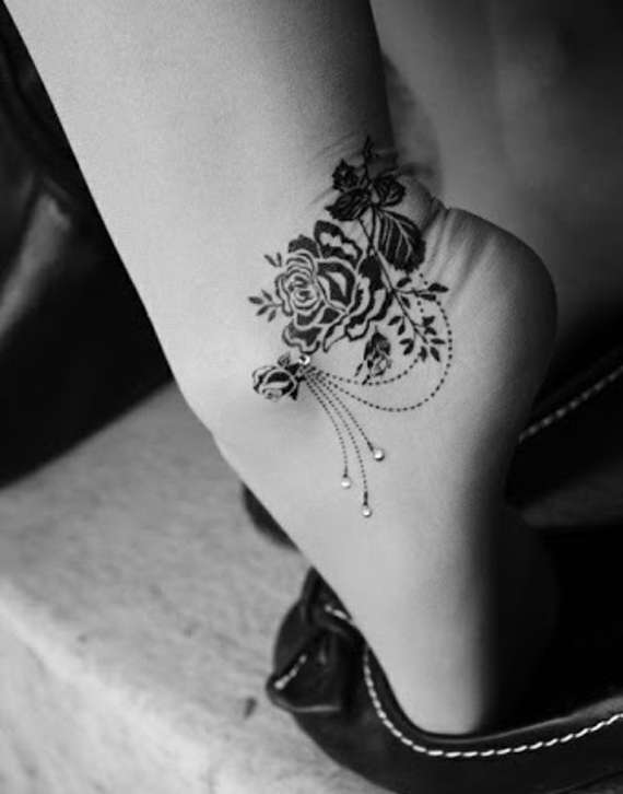 Black Ink Flowers Tattoo On Girl Left Ankle
