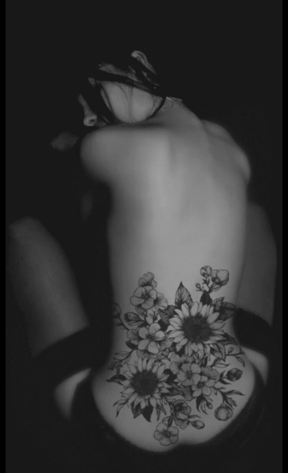 Black Ink Flowers Tattoo On Women Lower Back