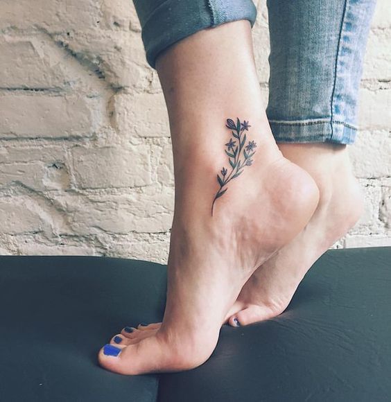 Black Ink Flowers Tattoo On Women Right Ankle