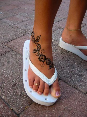 Black Ink Flowers Tattoo On Women Right Foot