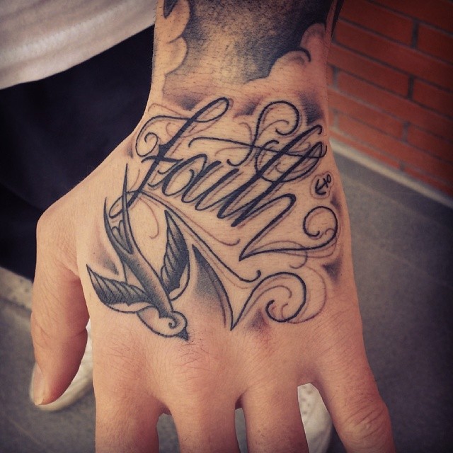 Black Ink Flying Bird With Faith Lettering Tattoo On Left Hand