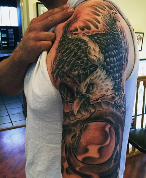 Black Ink Flying Eagle Tattoo On Man Left Half Sleeve