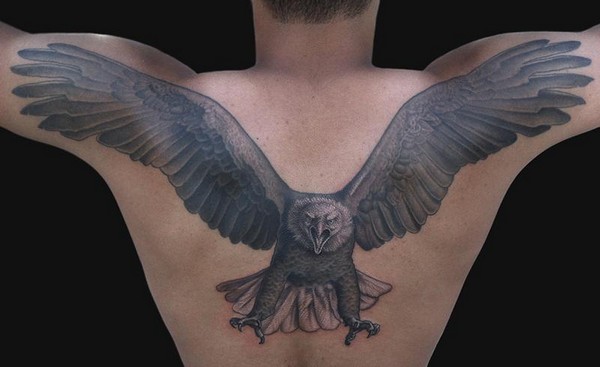 Black Ink Flying Eagle Tattoo On Man Upper Back