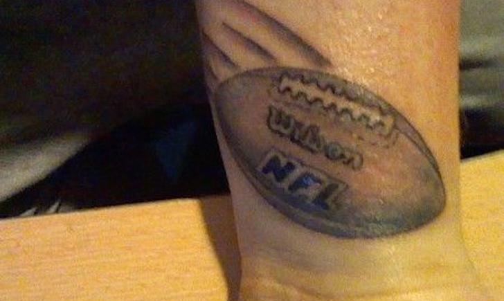 Black Ink Football Tattoo On Left Wrist