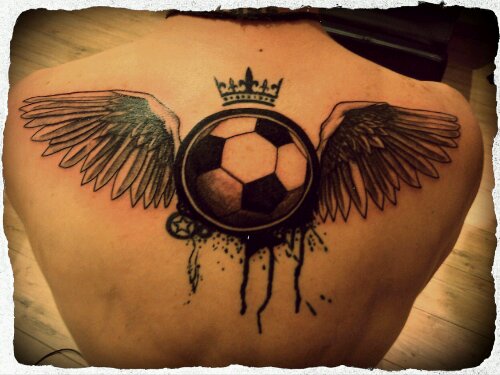 Black Ink Football With Wings Tattoo On Upper Back