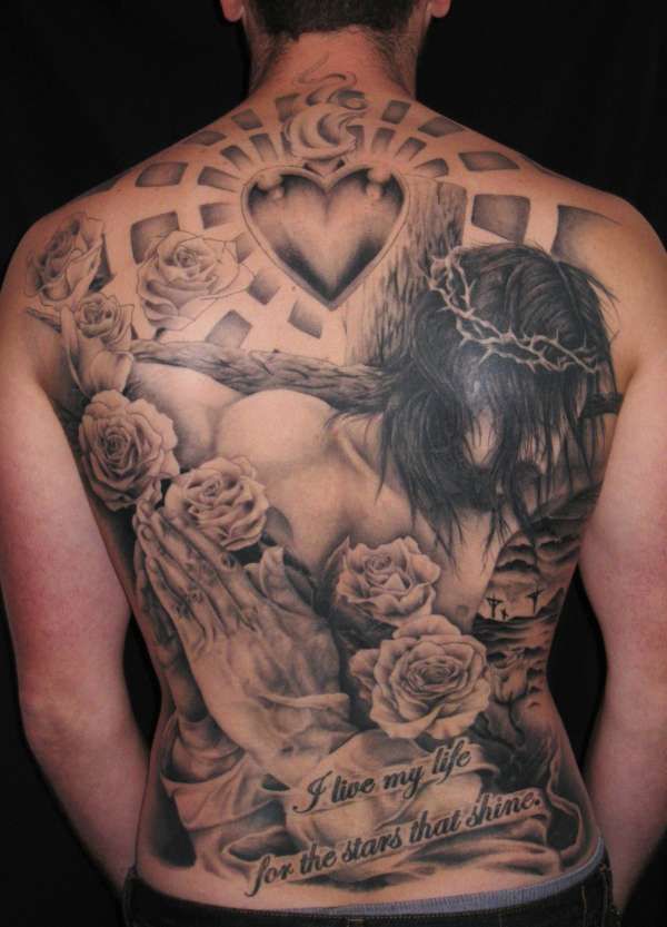 Black Ink Heart With Praying Hands And Roses Tattoo On Man Full Back