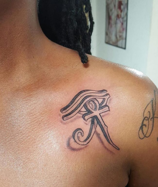 Black Ink Horus Eye With Ankh Tattoo On Left Front Shoulder