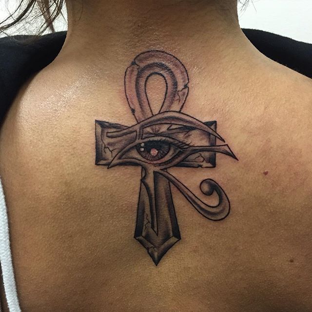 Black Ink Horus Eye With Ankh Tattoo On Upper Back