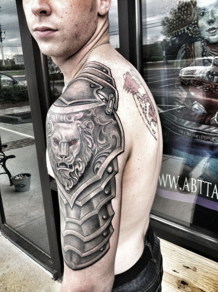Black Ink Lion Head On Armor Tattoo On Man Left Half Sleeve