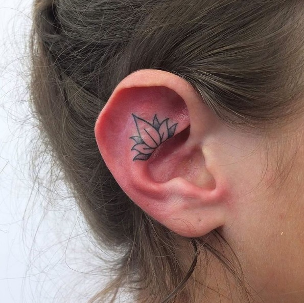 Black Ink Lotus Tattoo On Girl Right Ear
