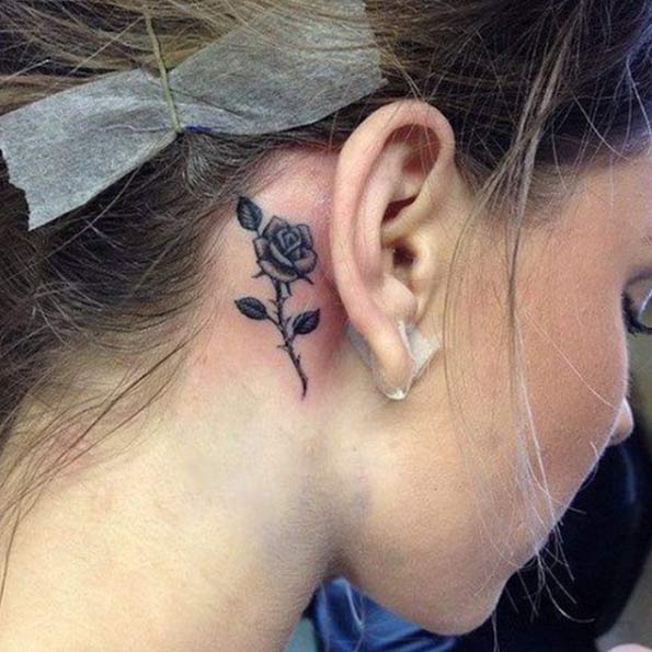 Black Ink Rose Tattoo On Right Behind The Ear