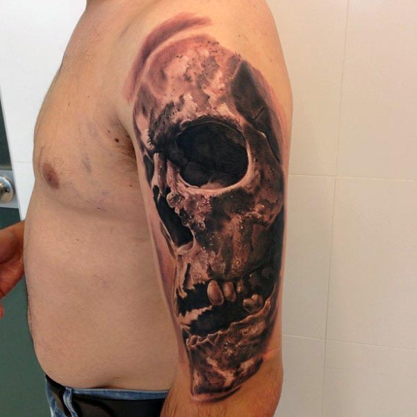 Black Ink Skull Tattoo On Man Left Upper Arm