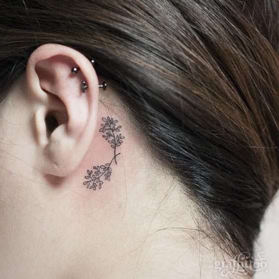 Black Leaves Tattoo On Girl Left Behind The Ear