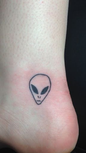 Black Outline Alien Head Tattoo On Left Ankle