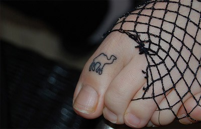 Black Outline Camel Tattoo On Left Foot Toe