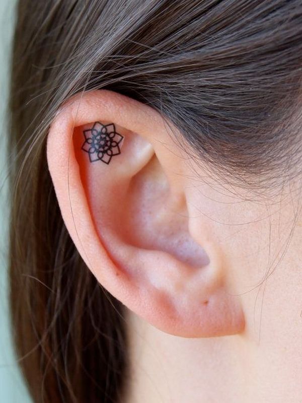 Black Outline Flower Tattoo On Girl Right Ear